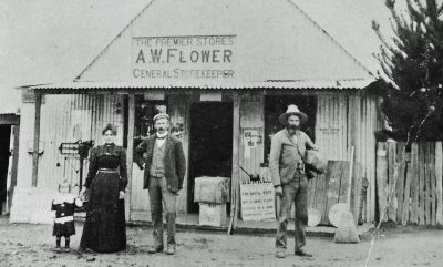 Milford Southwell (child) with parents Annie and Charles with Richard Southwell in front of Hall Store cropped
