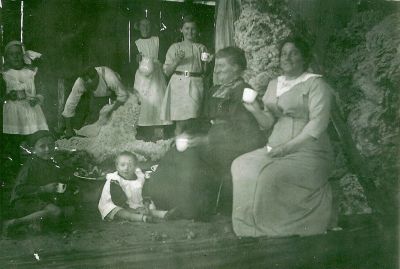 Shearing Shed Spring Flat - Nina sitting in front - Dot standing with white dress and bow & Clara Munday with jug
